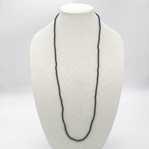 Long necklace with black acrylic beads.